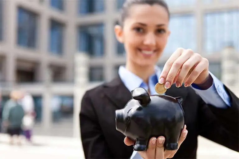 Photo of a woman holding a coin